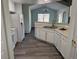 Bright kitchen featuring white cabinetry and countertops, perfect for meal preparation and entertaining at 7777 S Biloxi Way, Aurora, CO 80016