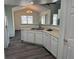 Efficient kitchen with white cabinets and modern appliances, offering both functionality and style for the home chef at 7777 S Biloxi Way, Aurora, CO 80016