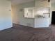 Open living area flows into the kitchen area with white cabinets, creating a functional and inviting space at 7777 S Biloxi Way, Aurora, CO 80016
