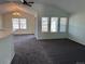 Bright living room with vaulted ceilings, a ceiling fan, and multiple windows that provide natural light at 7777 S Biloxi Way, Aurora, CO 80016