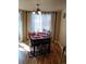 Bright dining room featuring a table with four chairs and large windows at 4572 Copeland Loop # 203, Highlands Ranch, CO 80126