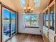 Bright dining area with hardwood floors, large windows, and a chandelier at 9485 W 81St Ave # B, Arvada, CO 80005