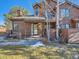 Inviting brown wood exterior of townhome with walkway and landscaping at 9485 W 81St Ave # B, Arvada, CO 80005