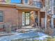 Front entrance of townhome with wreath and small porch at 9485 W 81St Ave # B, Arvada, CO 80005