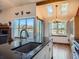 Kitchen island with granite countertop, sink, and view into dining area at 9485 W 81St Ave # B, Arvada, CO 80005