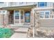 Close-up of townhome entrance showcasing stone pillars, covered entryway, and secure front door at 8943 Tappy Toorie Cir, Highlands Ranch, CO 80129