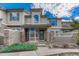 Charming townhome exterior featuring stone accents, covered entry, and well-manicured landscaping at 8943 Tappy Toorie Cir, Highlands Ranch, CO 80129