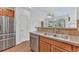 Kitchen featuring stainless steel refrigerator, sink and dishwasher, as well as wooden cabinets at 8943 Tappy Toorie Cir, Highlands Ranch, CO 80129