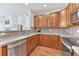 Well-lit kitchen showcasing stainless steel appliances, wooden cabinets, and ample counter space at 8943 Tappy Toorie Cir, Highlands Ranch, CO 80129