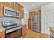 This kitchen features stainless steel appliances, including a microwave, oven, and refrigerator at 8943 Tappy Toorie Cir, Highlands Ranch, CO 80129