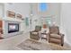 Cozy living room with fireplace, comfortable seating, and soaring ceilings for an airy feel at 8943 Tappy Toorie Cir, Highlands Ranch, CO 80129