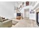 Open-concept living room with staircase, high ceilings, and seamless flow to other spaces at 8943 Tappy Toorie Cir, Highlands Ranch, CO 80129