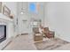 Bright living room with high ceilings, fireplace, and large windows offering natural light at 8943 Tappy Toorie Cir, Highlands Ranch, CO 80129