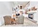 Bright living room showcases fireplace, staircase, and comfortable seating with seamless transition to dining at 8943 Tappy Toorie Cir, Highlands Ranch, CO 80129