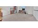 Bright living room with neutral carpeting, a large window, and space for a home office at 8943 Tappy Toorie Cir, Highlands Ranch, CO 80129