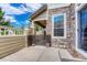 Stone patio features stone facade with window and decorative fence at 8943 Tappy Toorie Cir, Highlands Ranch, CO 80129