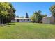 Expansive backyard with shed, mature trees, and a relaxing hammock area at 6436 S Kline St, Littleton, CO 80127
