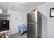 Basement showing a refrigerator, table, and cabinet on a soft gray carpeted floor at 6436 S Kline St, Littleton, CO 80127