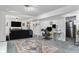 Open basement featuring cozy seating area, desk and adjacent door to another room at 6436 S Kline St, Littleton, CO 80127