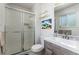 Cozy bathroom featuring a stylish sink, commode, and shower with sleek glass doors at 6436 S Kline St, Littleton, CO 80127