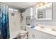 Bright bathroom features a shower-tub combo, stylish vanity, and ample storage at 6436 S Kline St, Littleton, CO 80127