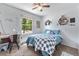 Bright bedroom with natural light, desk, ceiling fan and large window overlooking greenery at 6436 S Kline St, Littleton, CO 80127