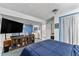 Bedroom with queen bed, entertainment center, and door to ensuite bathroom at 6436 S Kline St, Littleton, CO 80127