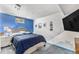 Bedroom with blue accent wall, comfy bed, and lots of natural light at 6436 S Kline St, Littleton, CO 80127
