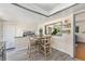 Cozy dining area with seating for four and a pass-through window to the living room at 6436 S Kline St, Littleton, CO 80127