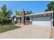 Charming single-Gathering home featuring an attached two-car garage and brick accents against blue sky at 6436 S Kline St, Littleton, CO 80127