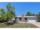 Charming single-Gathering home featuring a brick chimney and a well-maintained front yard at 6436 S Kline St, Littleton, CO 80127