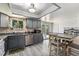 Bright eat-in kitchen with stainless steel appliances, gray cabinets, and backyard views at 6436 S Kline St, Littleton, CO 80127