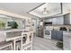 Open kitchen featuring stainless steel appliances, gray cabinets, and a casual dining area at 6436 S Kline St, Littleton, CO 80127
