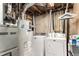 Functional laundry area with washer, dryer, water heater and ample space for cleaning supplies at 6436 S Kline St, Littleton, CO 80127