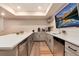 Modern basement kitchenette with white cabinets and quartz counters at 6437 Saddlesmith St, Castle Pines, CO 80108