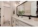 Double vanity bathroom with modern fixtures and white cabinets at 6437 Saddlesmith St, Castle Pines, CO 80108