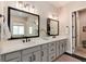 Modern bathroom with dual sinks, vanity, and large mirrors at 6437 Saddlesmith St, Castle Pines, CO 80108