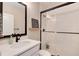 Clean bathroom with white subway tiles and black accents at 6437 Saddlesmith St, Castle Pines, CO 80108