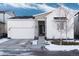 Craftsman style home with white siding, stone accents, and a two-car garage at 6437 Saddlesmith St, Castle Pines, CO 80108