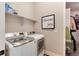 Convenient laundry room with washer, dryer, and shelving at 6437 Saddlesmith St, Castle Pines, CO 80108