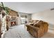 Cozy living room with stone fireplace and balcony at 18302 E Kepner Pl # 207, Aurora, CO 80017