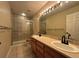 Well-lit bathroom featuring a double sink vanity, full mirror and tiled shower at 438 N Parkside Dr # C, Longmont, CO 80501