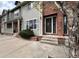 Close up of townhouse exterior with brick accents and well-manicured front yard at 438 N Parkside Dr # C, Longmont, CO 80501