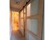 Hallway with glass paneled sliding doors and access to tiled bathroom at 438 N Parkside Dr # C, Longmont, CO 80501