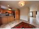 Open kitchen with wooden cabinets, granite countertops, and stainless steel appliances at 438 N Parkside Dr # C, Longmont, CO 80501