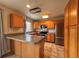 Well-equipped kitchen with breakfast bar, wood cabinets, and stainless steel appliances at 438 N Parkside Dr # C, Longmont, CO 80501