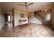 Spacious living room featuring tile floors, ceiling fan, and staircase access at 438 N Parkside Dr # C, Longmont, CO 80501