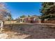 Spacious backyard featuring an enclosed sunroom and brick patio at 2365 S Holly Pl, Denver, CO 80222