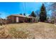 Brick home featuring a covered patio, sunroom, shed, and spacious yard at 2365 S Holly Pl, Denver, CO 80222