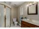 Well-lit bathroom features a glass-enclosed shower, tiled floors, and modern fixtures at 2365 S Holly Pl, Denver, CO 80222